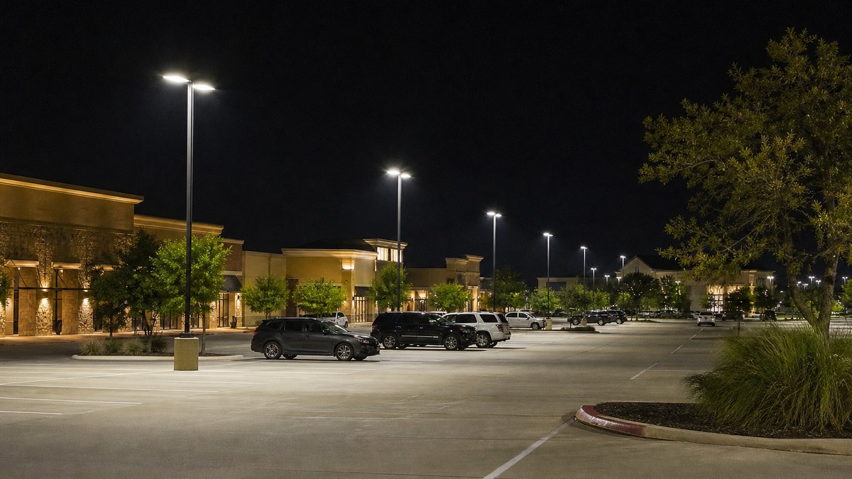 LED parking lot pole lighting at a South Arlington shopping center at night with even coverage